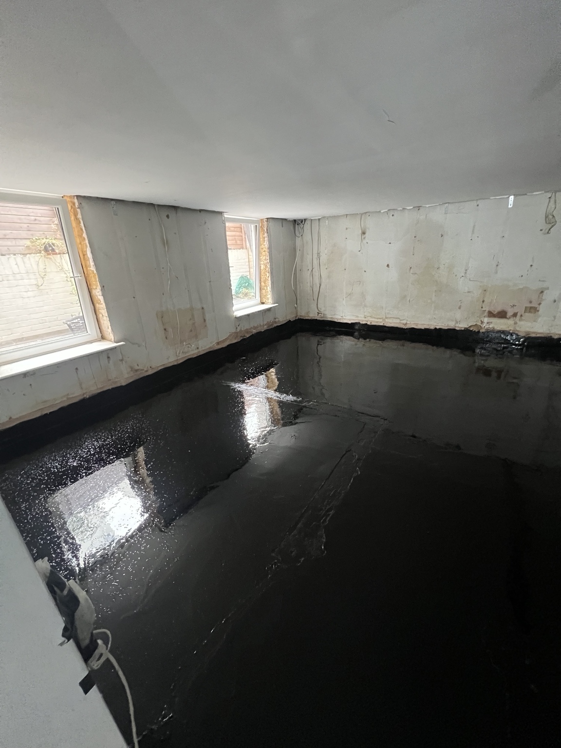 Waterproofing coating across basement floor