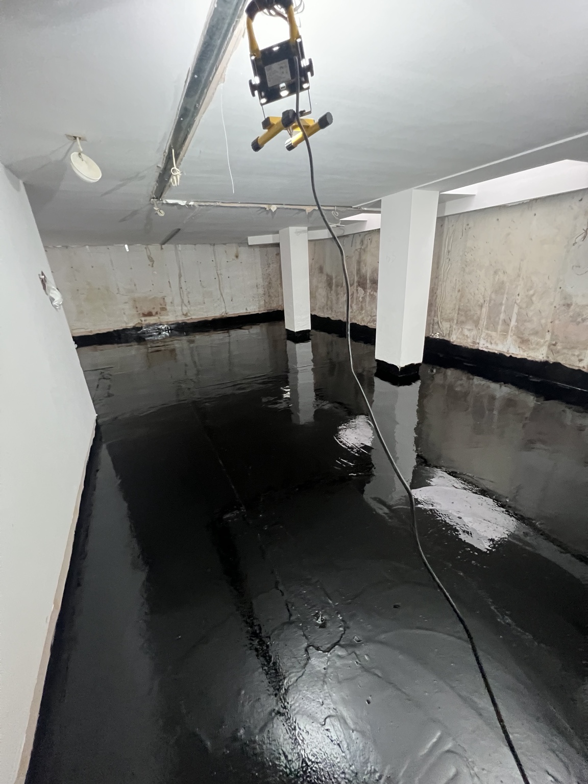 Waterproofing coating applied to basement floor